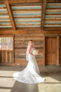 Bride poses inside the barn