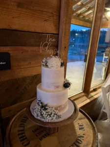 A multi-tiered wedding cake adorned with fresh flowers