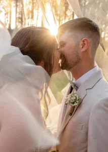 Newlyweds Dylan and Madison share a romantic kiss at sunset
