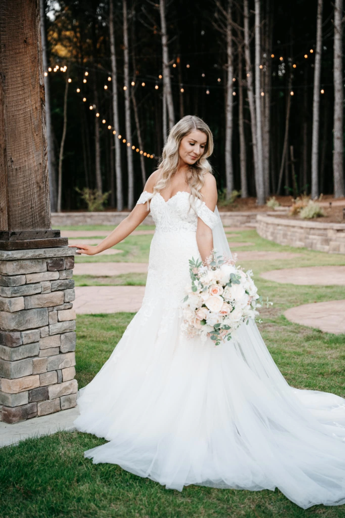 Close-up of Callie Reaves’ bridal portrait at Whispering Pines Venue, highlighting her elegant gown and serene expression amidst the venue’s greenery.