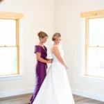 Bride posing for a pre-ceremony portrait at Whispering Pines Venue, wearing a timeless wedding gown with soft natural light.