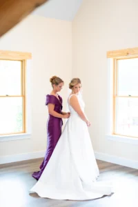 Bride posing for a pre-ceremony portrait at Whispering Pines Venue, wearing a timeless wedding gown with soft natural light.