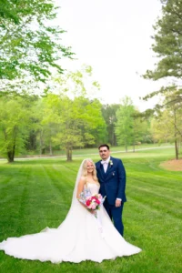 Bride and groom smiling together on their wedding day at Whispering Pines Venue in North Carolina.