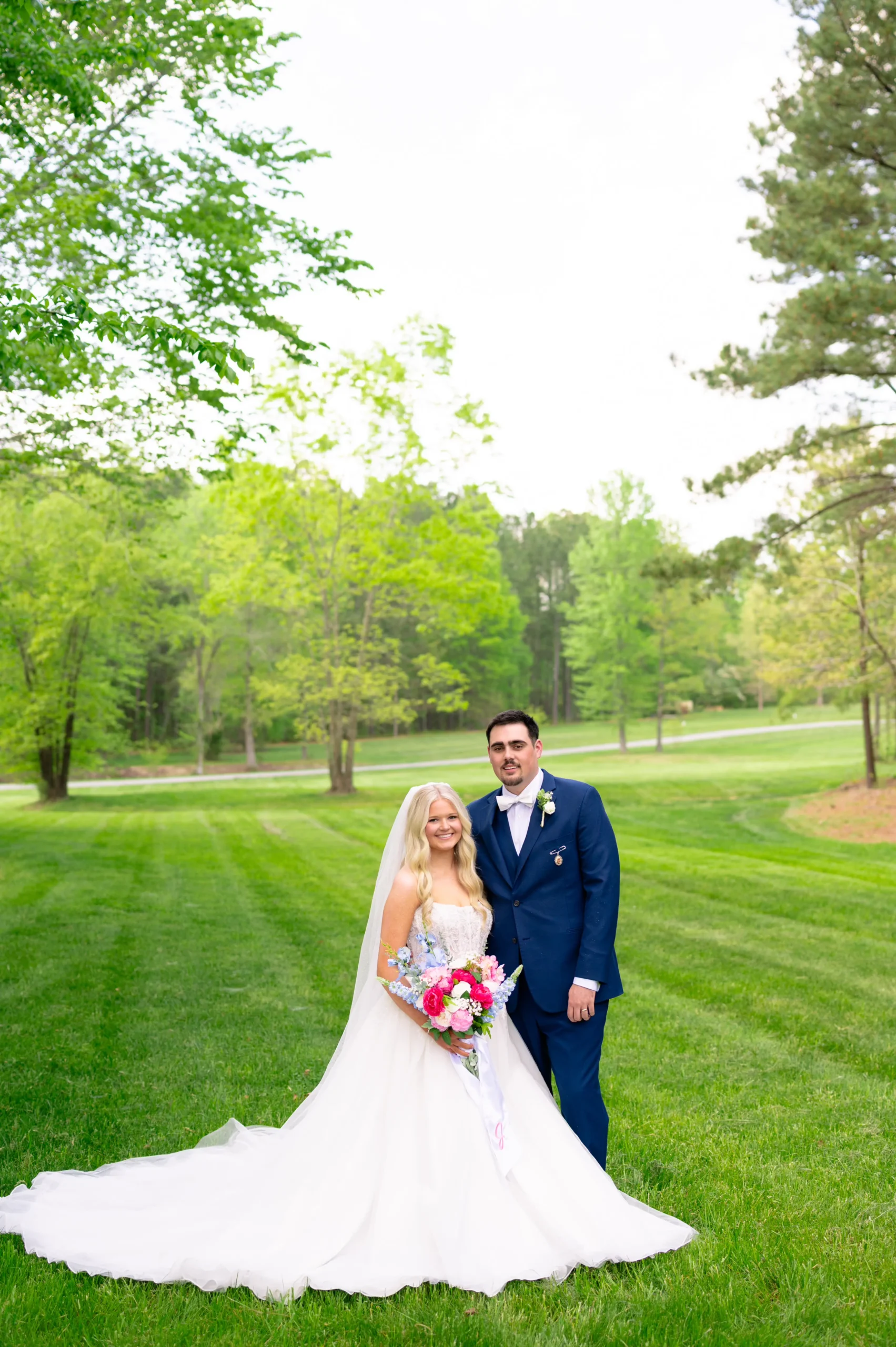 Bride and groom smiling together on their wedding day at Whispering Pines Venue in North Carolina.